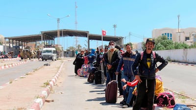 Tunisian workers stranded in Libya wait at the Ras Jedir border post to return to their country on April 21, 2020. AFP