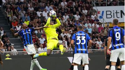 AC Milan goalkeeper Ciprian Tatarusanu catches the ball. AP
