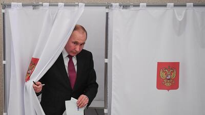 President Vladimir Putin walks out of a voting booth. AFP
