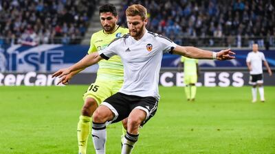 Valencia’s Shkodran Mustafi, right, will not be cheap should Arsenal secure his transfer. Geert Vanden Wijngaert / AP Photo
