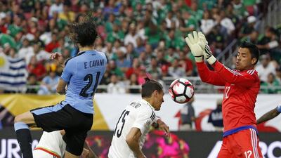 Mexico goalkeeper Alfredo Talavera saves a header from Uruguay’s Edinson Cavani during the second half of the Copa America Group C match at University of Phoenix Stadium Sunday, June 5, 2016, in Glendale, Arizona. Mexico defeated Uruguay 3-1. Ross D. Franklin / AP Photo