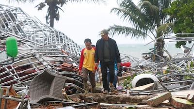 Locals walk through debris in Pandeglang. EPA
