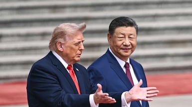 TOPSHOT - US President Donald Trump (L) takes part in a welcome ceremony with China's President Xi Jinping at the Great Hall of the People in Beijing on May 14, 2026. (Photo by Brendan SMIALOWSKI / AFP)