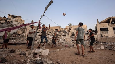 Children play volleyball on a court made from rubble in Gaza city. AFP