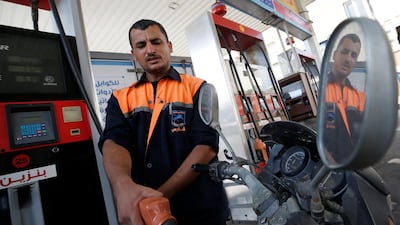 A Palestinian worker fills a motorbike with fuel at a petrol station in Gaza City. Reuters