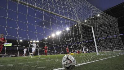 Real Madrid’s Portuguese striker Cristiano Ronaldo scores his second goal during the UEFA Super Cup football match between Real Madrid and Sevilla at Cardiff City Stadium in Cardiff, south Wales on August 12, 2014. Cristiano Ronaldo upstaged new team-mates Toni Kroos and James Rodriguez and homecoming hero Gareth Bale as Real Madrid beat Sevilla 2-0 in Cardiff on Tuesday to win the UEFA Super Cup. AFP PHOTO / GLYN KIRK