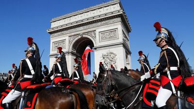 French Republican Guards ride their horse pas the Arc de Triomphe in Paris, Friday, July 14, 2017. Paris has tightened security before its annual Bastille Day parade, which this year is being opened by American troops with President Donald Trump as the guest of honor to commemorate the 100th anniversary of the United States' entry into World War I. (Etienne Laurent, Pool via AP)