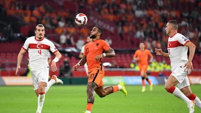 Netherlands' Memphis Depay in action with Turkey's Caglar Soyuncu. Reuters