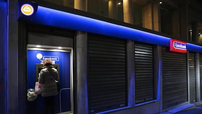 A woman withdraws cash from a Eurobank ATM in Athens February 16, 2015. The European Central Bank allowed Greek banks access to extra emergency financing from the Bank of Greece because deposit outflows have picked up. Yannis Behrakis / Reuters
