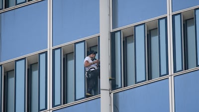 Robert, who holds a world record for urban climbing, surrendered to a "cat and mouse" chase. Ed Jones / AFP