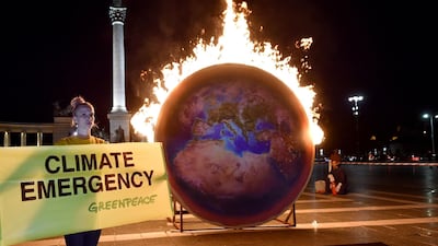 The Earth on fire is seen during a Greenpeace protest at the Heroes square in Budapest. AFP