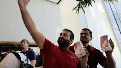 A customer take a selfie outside the Apple store at Dubai Mall. Mahmoud Khaled / EPA