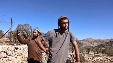 Israeli settlers disrupt Palestinian farmers' harvest in the occupied West Bank. AFP.