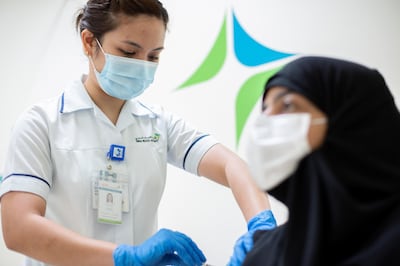 A woman receives a Covid-19 vaccination in Dubai. EPA