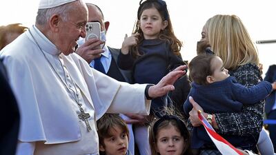 Pope Francis greets people upon his arrival in Larnaca. AFP