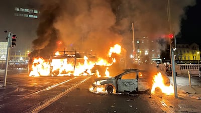 Vehicles burn in Dublin city centre amid violent scenes sparked by a knife attack that injured five people, including three children, on November 23. PA