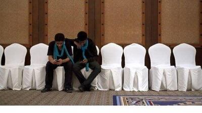 Volunteers take a break in between their duties at the Dubai International Film Festival yesterday. Jeff Topping / The National