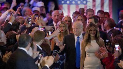 Republican presidential candidate Donald Trump is joined by his wife Melania, right, and daughter Ivanka as he greets supporters as he arrives for a primary night news conference, Tuesday, May 3, 2016, in New York. (AP Photo/Mary Altaffer)