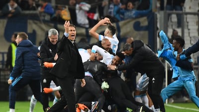 Marseille's French coach Rudi Garcia and players celebrate after winning the Europa League quarter-final second leg against RB Leipzig at the Velodrome in Marseille, on April 12, 2018. AFP