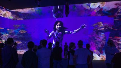 Visitors watch the ocean environmental awareness video at the Australia Pavilion.