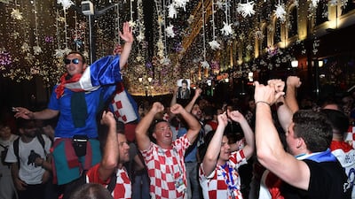 Croatian team supporters celebrate their win in semi-final match on Nikolskaya street in centrak in Moscow. The flow of foreign and domestic visitors around Russia is giving retailers a boost. AFP