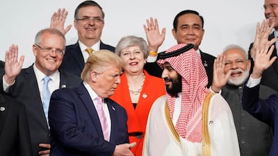 US President Donald Trump offers his hand to Saudi Arabia's Crown Prince Mohammed bin Salman during the family photo of G20 leaders at the Osaka Summit. Reuters