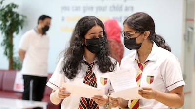 Greeshma Giridas, left, and Erin Isabel look over their A-level results at Cambridge International School in Dubai. Pawan Singh / The National
