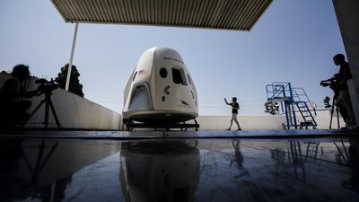 An attendee takes pictures of a mock up of the Crew Dragon spacecraft ahead of the NASA Commercial Crew Program astronaut visit at the SpaceX headquarters in Hawthorne, California. Patrick T Fallon/Bloomberg