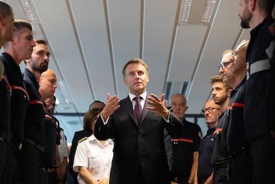 French President Emmanuel Macron thanks emergency workers in Gironde during a visit to the fire-stricken region on Monday. AFP