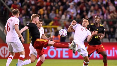 Kevin De Bruyne, left, and Poland's Jan Bednarek fight for the ball. AP