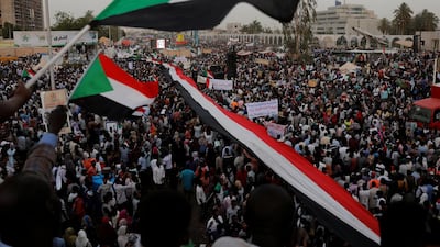 Thousands of protesters wave Sudanese flags, hold banners and chant slogans during a demonstration in front of the Defence Ministry in Khartoum. Reuters