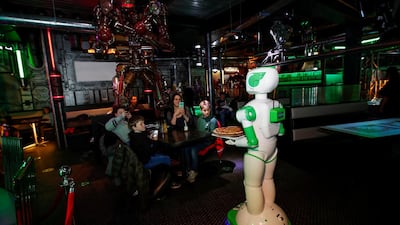 A robot delivers a pizza at a restaurant in the UK. The UAE is projected to benefit the most in the region from AI adoption. Reuters