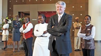 Staff at the Movenpick Ambassador Hotel Accra in Ghana, wearing uniforms designed by Emile Rassam