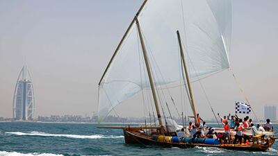 The Hasheem team celebrate after crossing the finish line of the annual long-distance dhow sailing race, known as Al Gaffal, near Sir Abu Nuair island towards Dubai. AFP