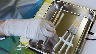 A medial personal prepares the Moderna Covid-19 vaccine for members of local fire departments at a temporary mass vaccination center at a former Tsukiji fish market site set up by Tokyo metropolitan government. AP Photo