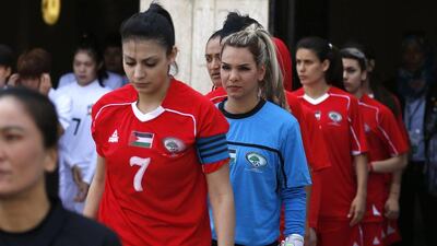 Palestinian women's football players take the field before a qualifying match against Thailand for the Asian Women football Cup in the West Bank town of al-Ram on April 3, 2017. Abbas Momani / AFP