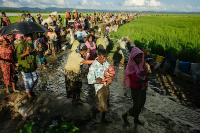 Hundreds of Rohingya wait after crossing Bangladesh's border as they flee from Budichong, Myanmar on October 9, 2017. EPA
