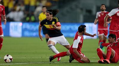 Colombia’s Radamel Falcao, centre, cuts across the Kuwait defence at Zayed Sports City in Abu Dhabi on Monday night. Christopher Pike / The National