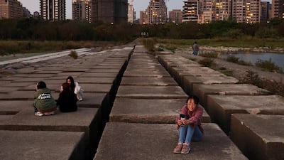 People take photos on the exposed riverbed of Taiwan's Touqian river, a main water source for Hsinchu Science Park where major semiconductor companies are based, in Hsinchu, Taiwan. Reuters