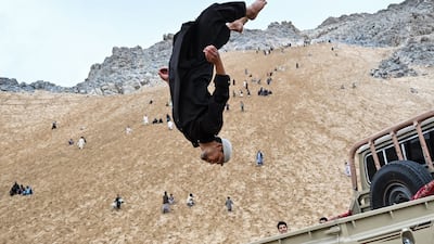 An Afghan parkour athlete performs a stunt at a sandy mountainside in Reg-e-Rawan, Kapisa province. AFP