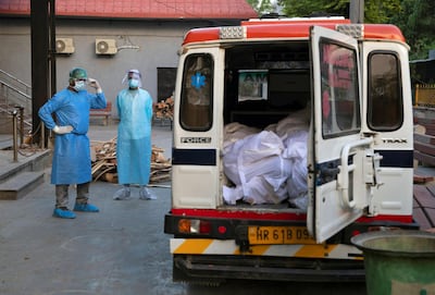 An ambulance driver waits for the relatives to unload the bodies of Covid-19 victims at a crematorium in New Delhi on June 11, 2020. Reuters