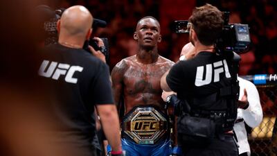 Israel Adesanya celebrates with the middleweight belt after knocking out Alex Pereira at UFC 287.