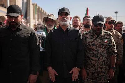 The commander-in-chief of Iran's Islamic Revolutionary Guard Corps, Ahmad Vahidi, centre, pays his respects to late supreme leader Ayatollah Ali Khamenei at the Imam Khomeini Grand Mosalla in Tehran on Sunday. Reuters