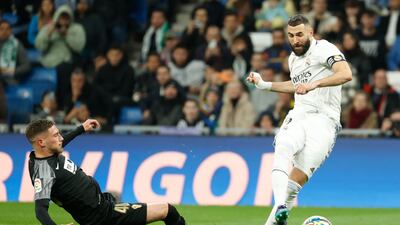 Real Madrid's Karim Benzema in action against Elche's Jose Angel Carmona. EPA