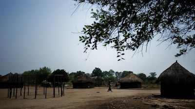 A village in rural Mozambique provides the setting for Mia Couto’s novel. Above, A woman walks through Vinho village in the country’s Gorongosa National Park. AFP