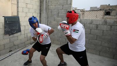 Jordanian brothers Hussein and Zeyad Ashish, boxers who qualified for the next Olympics, train on the roof of their home at Al Baqaa Palestinian refugee camp, near Amman. Reuters