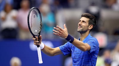 Novak Djokovic of Serbia celebrates winning the first set despite his hurt shoulder. AFP