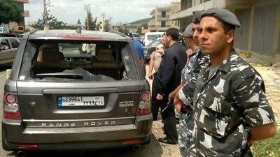 Lebanese security stands by the car in which the Sunni cleric, Sheikh Ahmed Abdul Wahid, and another member of a political alliance against the Syrian president, Bashar Al Assad, were shot dead yesterday by Lebanese soldiers, near Halba town in north Lebanon.