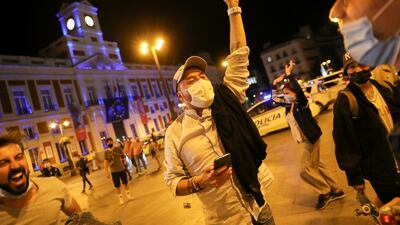People celebrate the lifting of the state of emergency decreed by the Spanish Government to prevent the spread of Covid-19 at Puerta del Sol square in Madrid. Reuters