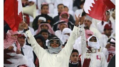Qatari fans wave the flag prior to their team's Asian Cup match against China in Doha on Tuesday. All of Qatar are in a buoyant mood after their nation clinched the bid to host the 2022 World Cup.